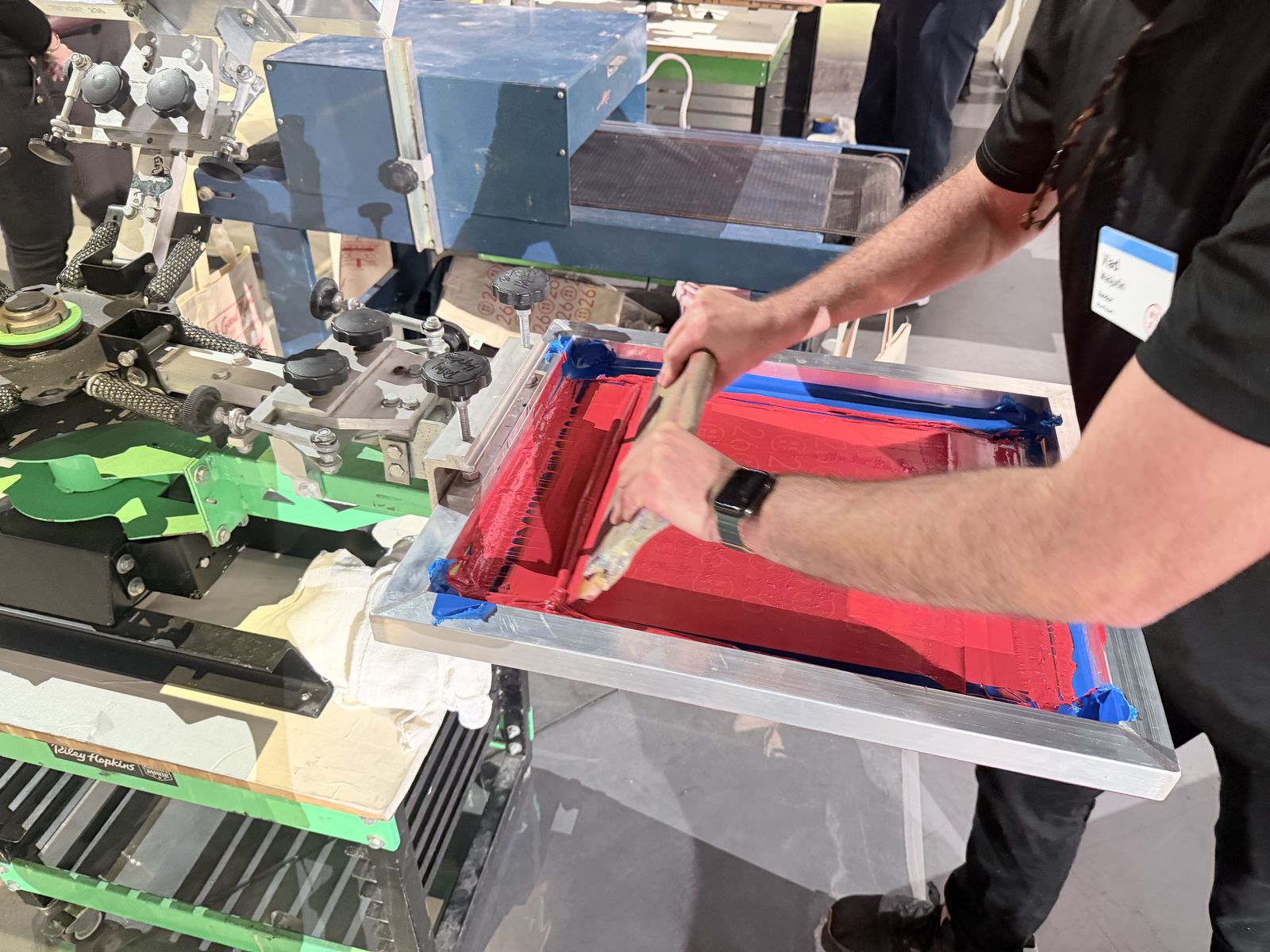 Close-up of a technician working color across a frame during pre-event production
